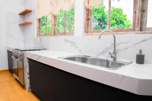 a kitchen with a sink and a window at Bali Invest Living in Canggu