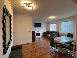 a living room with a table and a couch at Kristály Apartman in Szeged