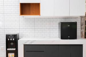 a kitchen with a counter top with a black appliance at Bali Invest Living in Canggu