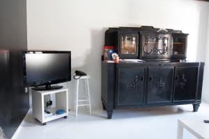 a black entertainment center with a tv and a television at Houses of Motovun in Motovun