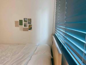 a bedroom with a bed and a window with blinds at Korean Folk village stay in Yongin