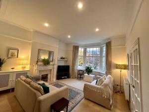 a living room with two couches and a fireplace at Holland House in New Brighton