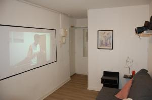 a living room with a large picture on the wall at Jacobin-centre ville-paisible-2 couchages in Amiens