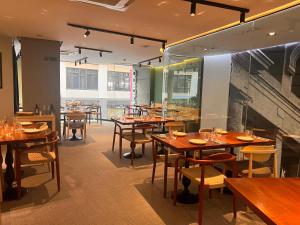 a dining room with wooden tables and chairs at Hotel Indigo Madrid - Gran Vía by IHG in Madrid