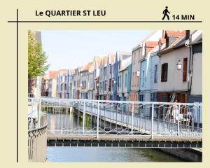 a bridge over a river in a city with buildings at Jacobin-centre ville-paisible-2 couchages in Amiens