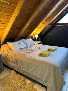 a bedroom with a bed with two towels on it at House in El Chalten