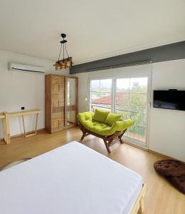 a room with a bed and a couch and a television at Lb Boutique Hotel in Kumluca