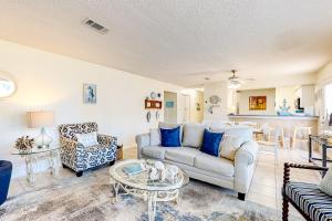 a living room with a couch and a table at Beachview #105 in Navarre