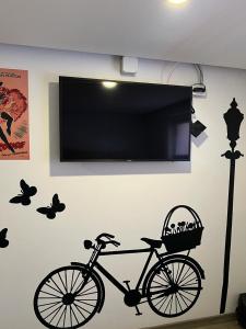 a black bike on a wall with butterflies on it at Dubai vip in Bogotá