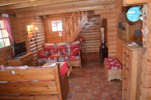 a log cabin with a staircase and a living room at LE MARLOTTE in Sapois