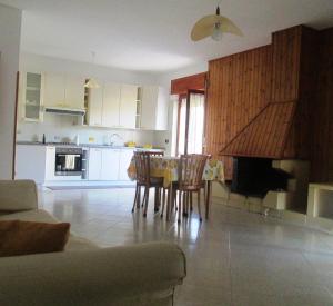a kitchen and dining room with a table and chairs at Casa Velina in Castelnuovo Cilento