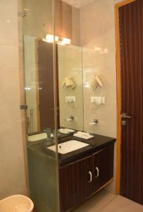 a bathroom with a sink and a mirror at Hotel Gurveer Royal in Lucknow