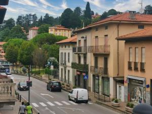 a view of a city street with cars and buildings at Room in shared apartment, near Lecco in Calolziocorte