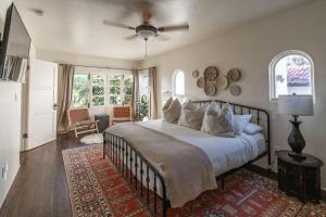 a bedroom with a large bed with a ceiling fan at Ocean View Spanish Beauty Half Block to Beach in San Diego