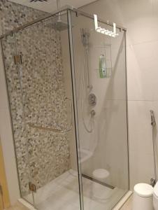 a shower with a glass door in a bathroom at Yas Getaway in Abu Dhabi
