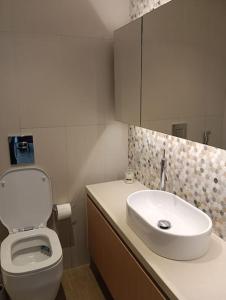 a bathroom with a white toilet and a sink at Yas Getaway in Abu Dhabi