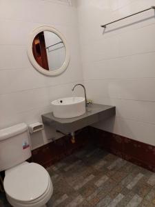 a bathroom with a white toilet and a sink at N.D.Hotel in Ko Lanta