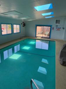 a swimming pool with blue lights in a room at Seabird Lodge Fort Bragg in Fort Bragg
