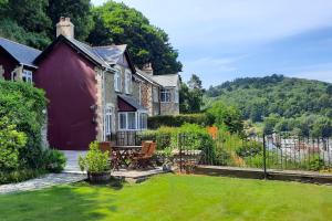 a house with a garden in front of it at A 3 bed cottage in Exmoor with fantastic sea views in Lynmouth