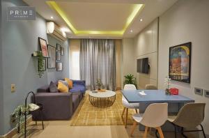 Prime Residence New Cairo في القاهرة: غرفة معيشة مع أريكة وطاولة