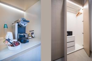 a kitchen with a counter with a mixer and a cabinet at Hotel Galanias in Bari Sardo