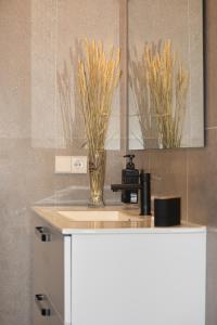 a bathroom counter with a sink and a mirror at Sohosuites Campello Beach in El Campello