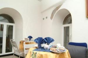 a dining room with a table and chairs and two arches at Hotel Acquario in Genova