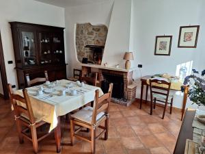 a dining room with a table and a fireplace at Casale San Felice B&B in Cusano Mutri +37 photos