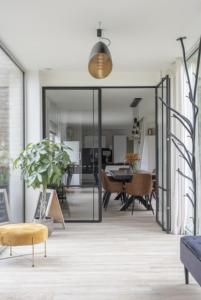 a living room with a sliding glass door at De Groene Bever in Lo-Reninge