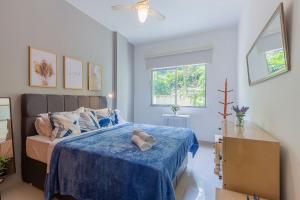 a bedroom with a bed with a teddy bear on it at Copacabana Beachside Retreat in Rio de Janeiro