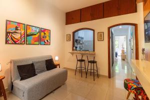 a living room with a couch and a bar at Copacabana Beachside Retreat in Rio de Janeiro
