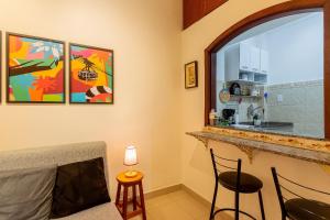 a living room with a counter and a kitchen at Copacabana Beachside Retreat in Rio de Janeiro