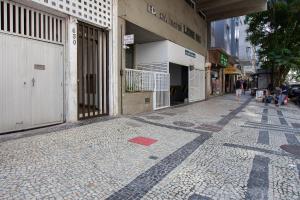 an empty street with a building and people walking down it at Copacabana Beachside Retreat in Rio de Janeiro