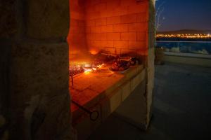 a brick oven with a pizza on top of it at Santa Lucia - Villa&Boat in Turanj
