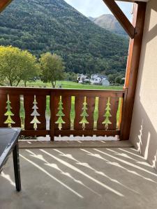 a balcony with a wooden fence with trees painted on it at Appartement V de ROLAND Luz VDR212 in Luz-Saint-Sauveur