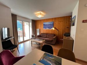 a living room with a couch and a table at Appartement V de ROLAND Luz VDR212 in Luz-Saint-Sauveur