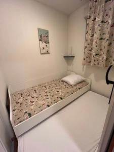 a small bedroom with a bed in the corner at Appartement V de ROLAND Luz VDR212 in Luz-Saint-Sauveur +2 photos