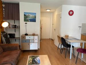 a living room with a table and a couch at Appartement V de ROLAND Luz VDR212 in Luz-Saint-Sauveur
