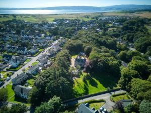 an aerial view of a town with a house in the trees at Woodlands Bed and Breakfast in Dornoch