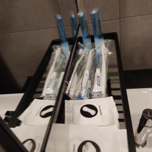a group of toothbrushes in plastic bags on a table at Urban Suites Jsw in Jelutong