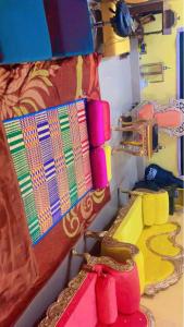 a close up of a bed with colorful pillows at Mahavatar Babaji Farm Stay in Bangalore