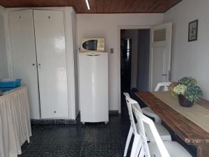 a dining room with a table and a white cabinet at Casa Orión in La Paloma