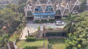 an aerial view of a building with a car parked in front at Richhariya Nature's Retreat Homes in Jhānsi