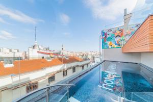 a balcony with a swimming pool on a building at Hotel Indigo Madrid - Gran Vía by IHG in Madrid