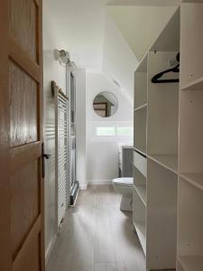 a white bathroom with a toilet and a window at Maison, cottage in Choisy-au-Bac +32 photos