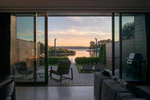 a screened in porch with a view of the water at GABA villas in Vyshhorod