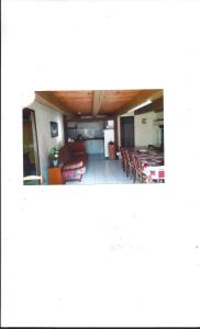 a view of a living room with tables and chairs at LA TOUR D'AUVERGNE in Juilles