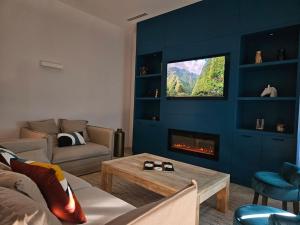 a living room with a couch and a fire place at Le Petit Versailles Loire Tours in Rochecorbon