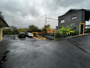 a parking lot with cars parked in front of a building at Superbe appartement entre lac et montagne. in Veyrier-du-Lac