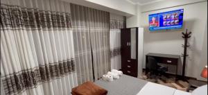 a bedroom with a bed and a desk and a television at hotel boulevard in Minas de Marcona